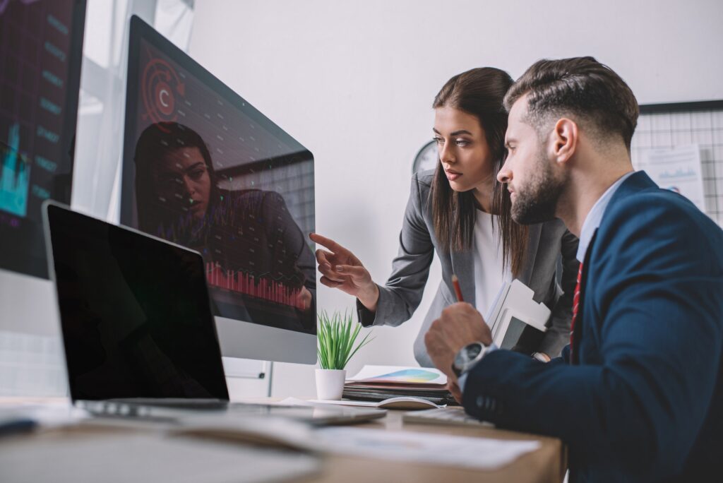 selective focus of information security analysts using charts on computer monitors while working in.jpg